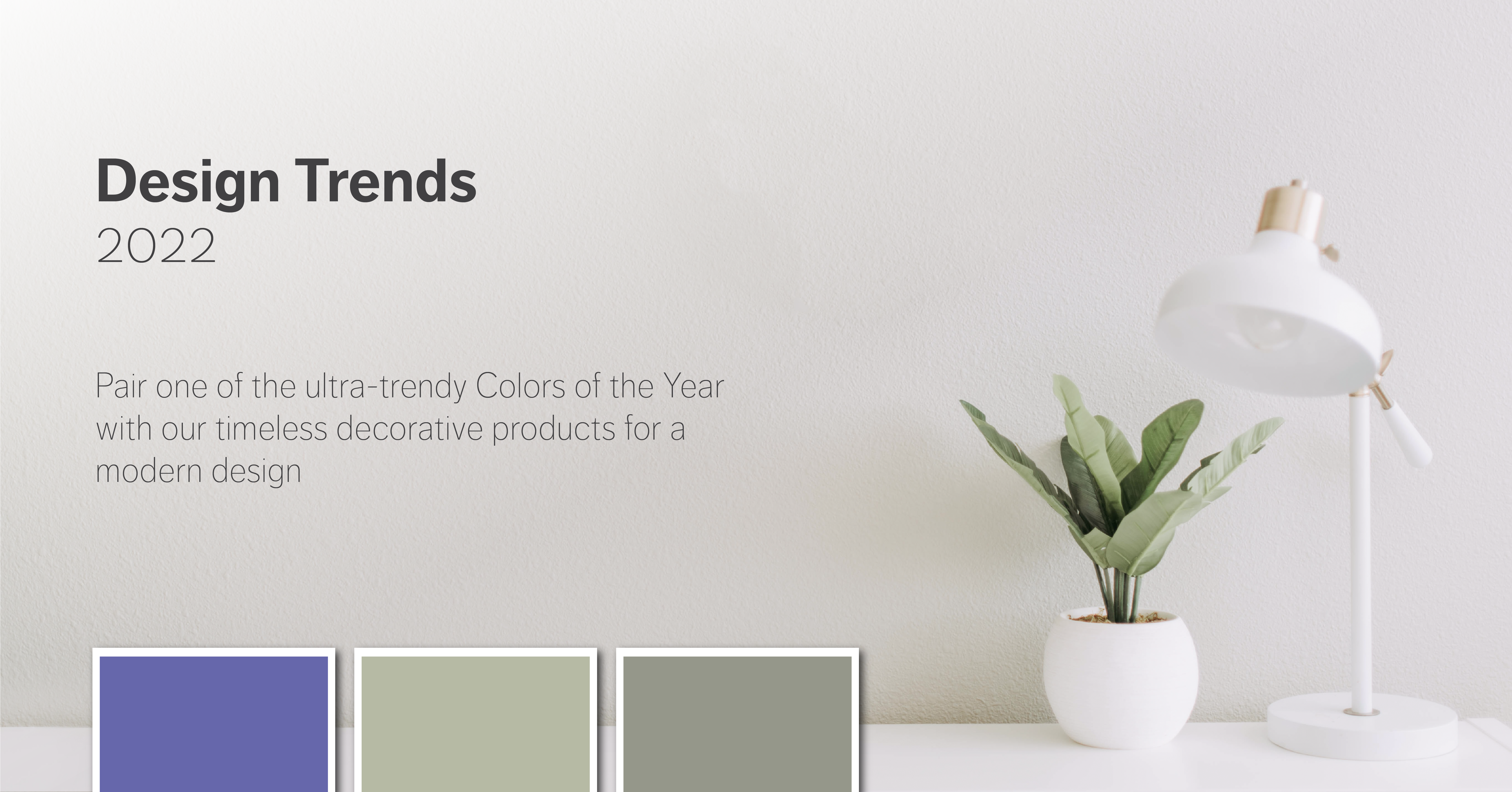 A white lamp and potted plant sit on a white desk. The words "Design trends 2022" are overlaid.